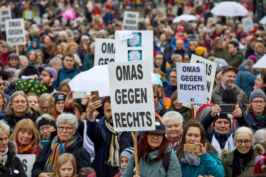 15 February 2020, Hamburg: Participants hold banners with the inscription 